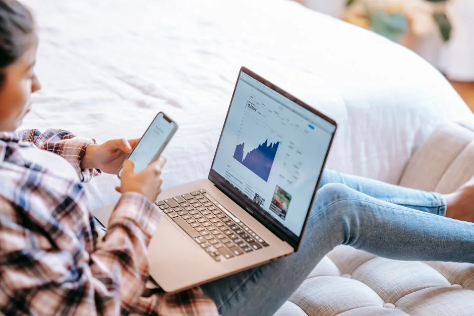 Close-up view of a woman working on a digital marketing project in a home office environment.